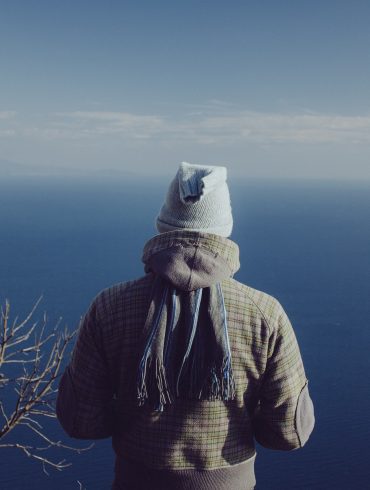 person in jacket on the sea background