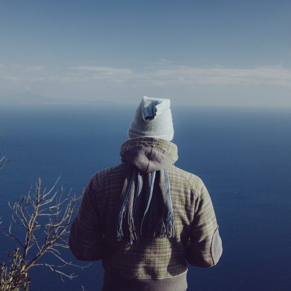 person in jacket on the sea background